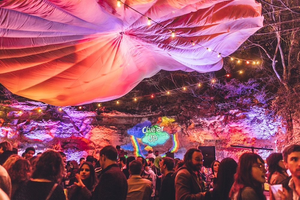 A diverse crowd enjoys live music at an outdoor venue.